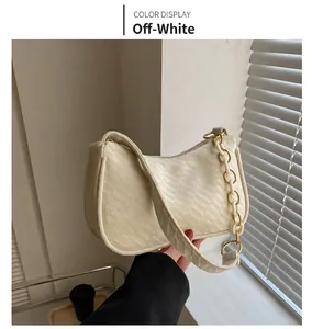 Detail of off-white quilted shoulder bag with chic acrylic chain and soft striped texture