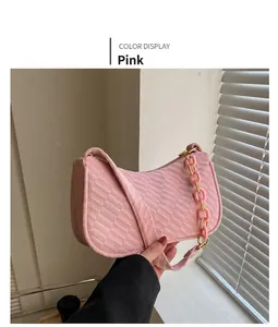 Detail of pink velvet baguette bag with woven texture and matching chunky chain strap