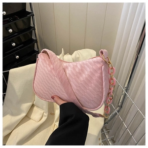 Pink velvet underarm bag with woven texture and gold chain strap detail