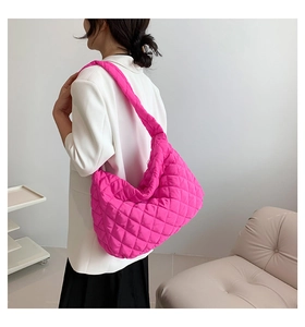 Detail of rose pink quilted tote bag with diamond lattice pattern and soft texture