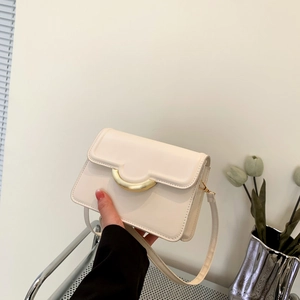Minimalist creamy white flap crossbody bag with elegant golden metallic buckle accent