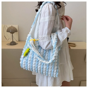 Detailed macro view of the blue and white pleated bubble fabric on a large tote bag