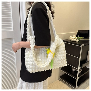 Detail of white popcorn texture tote bag with neon acrylic chain and stylish plush charm
