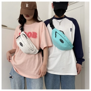 Matching set of white and blue nylon crossbody bags with adjustable black straps and zippers