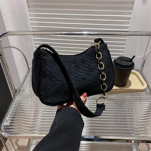 Women's black velvet shoulder bag with chunky gold chain strap for trendy urban style