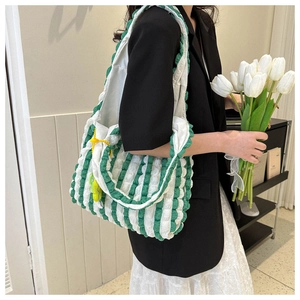 Detail of green and white popcorn textured shoulder bag showing large capacity and pattern