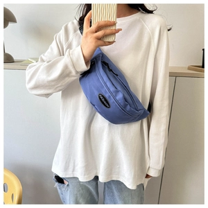 Blue nylon waist bag with Fashion label shown in a mirror selfie lifestyle shot