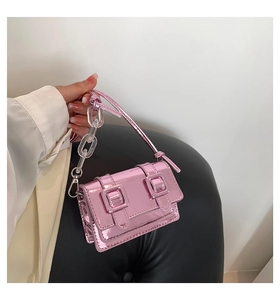 Detail of pink metallic mini crossbody bag with mirror finish and acrylic chain strap