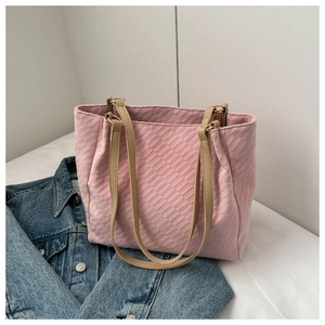 Close-up of pink embossed woven texture and leather handles on this large tote bag