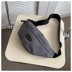 Detailed view of grey nylon crossbody waist bag with black adjustable strap and fashion logo