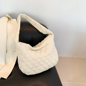 Chic cream quilted puffer hobo bag with classic diamond stitch and wide shoulder strap