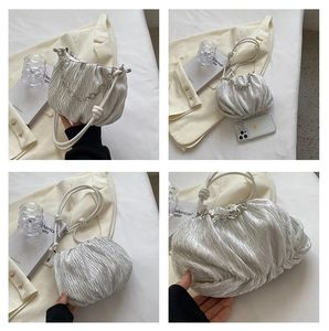 Detail view of silver ruched cloud bag with metal chain and knotted strap from four angles