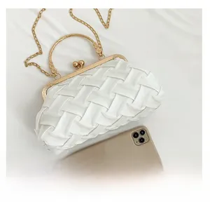 White woven evening bag with gold clasp and chain strap shown next to a smartphone