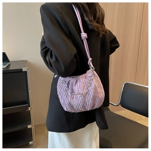 Detail of light purple pleated shoulder bag with decorative silver floral metal chain