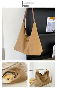 Detail of khaki suede tote bag showing rhombus texture and brown leather shoulder strap