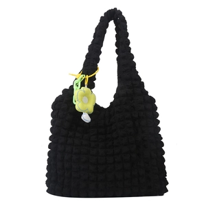 Black popcorn texture shoulder tote bag with yellow daisy charm and green chain strap