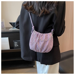 Detail of light purple pleated cloud bag featuring silver flower chain and soft texture