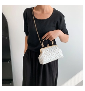 White woven clutch with golden metal handle featuring bead accents and chain strap