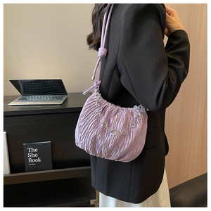Detail of purple pleated cloud bag with silver floral chain and fine shoulder strap