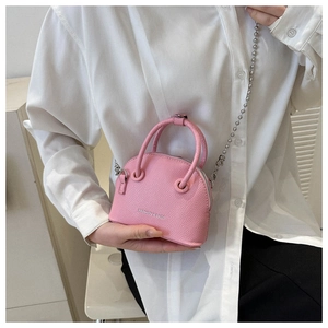 Close-up of pink shell bag with lychee grain texture and metal bead chain strap