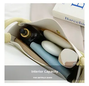 Detail view showing interior capacity of a light yellow square bag with daily essentials