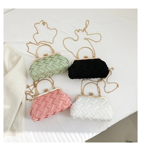 Detailed view of woven satin evening clutches in green, black, pink and white options