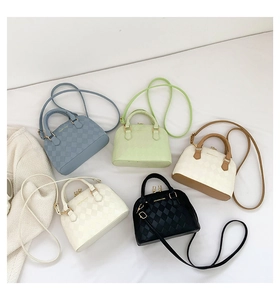 Detailed view of mini shell bags in blue, green, beige and black with gold zippers