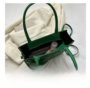 Top view of green quilted tote bag interior showing spacious capacity for daily essentials