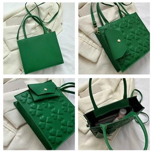 Detail of green square handbag with textured clover pattern and matching mini coin purse
