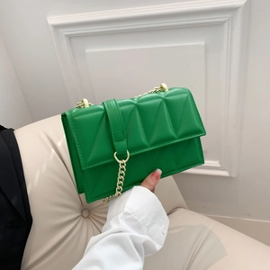 Fashionable green quilted shoulder bag with gold chain strap and geometric stitching