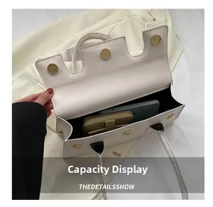 Top view showing the spacious interior capacity of this cream structured handbag
