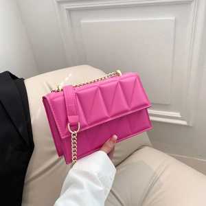 Chic magenta quilted crossbody bag with gold chain strap and geometric stitch pattern