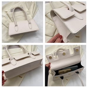 Detail view of a beige rectangular handbag showing the interior capacity and magnetic closure