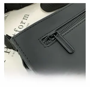 Detailed macro view of the smooth black metal zipper on a stylish matte PU leather handbag