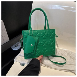 Close-up of green embossed clover pattern on PU leather tote bag with small coin purse