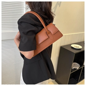 Brown rectangular leather shoulder bag shown on model for size and fit perspective