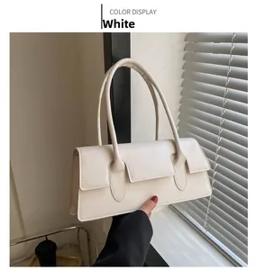 Detail of white PU leather rectangular handbag with slim handle and flap closure