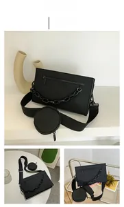 Detail of black PU crossbody bag featuring chunky chain decor and small round coin purse