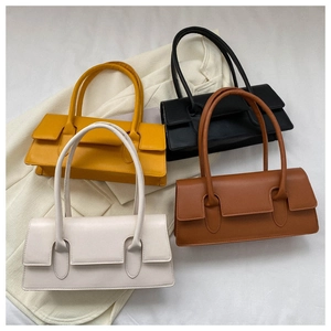 Flat lay of colorful French style faux leather baguette bags on elegant fabric background