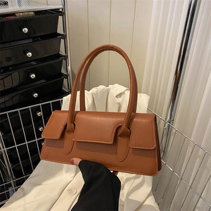 Chic brown leather baguette shoulder bag with long handles and a sleek flap closure