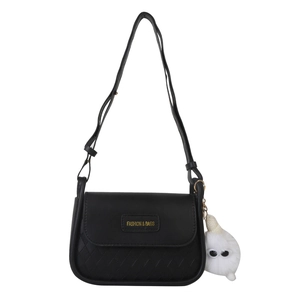 Chic black quilted crossbody bag with a plush charm and adjustable shoulder strap
