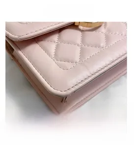 Macro shot of pink quilted leather bag featuring gold hardware and fine stitching detail