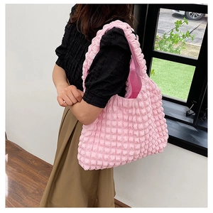 Detail of pink bubble texture tote bag showing puffy fabric and spacious shoulder design