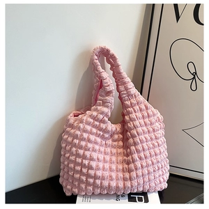 Close-up of pink puff flower tote bag showing quilted bubble texture and soft fabric