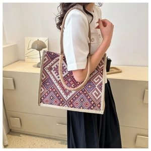 Detail of bohemian geometric woven tote bag with durable rope handles for women