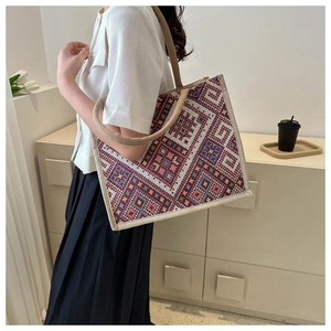 Close-up of geometric ethnic woven canvas tote bag with textured bohemian pattern detail