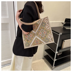 Detailed view of bohemian canvas tote with geometric patterns and woven handle