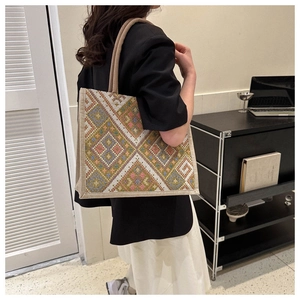 Close-up of bohemian embroidered canvas tote bag with colorful geometric patterns