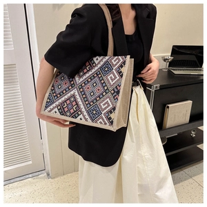 Detail of colorful geometric jacquard pattern and woven shoulder straps on canvas tote bag