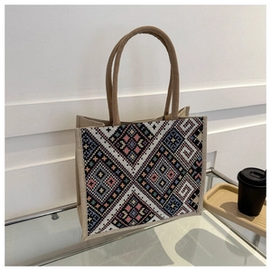 Detailed view of bohemian canvas tote bag featuring geometric rhombus embroidery patterns